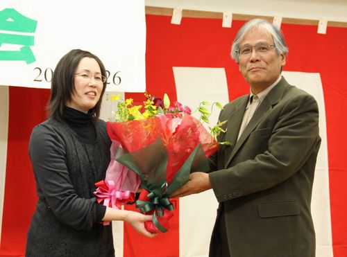 勝利報告会で祝福される、小池克則さんの妻で原告の小池友子さん（左）＝１１月２６日、名古屋市